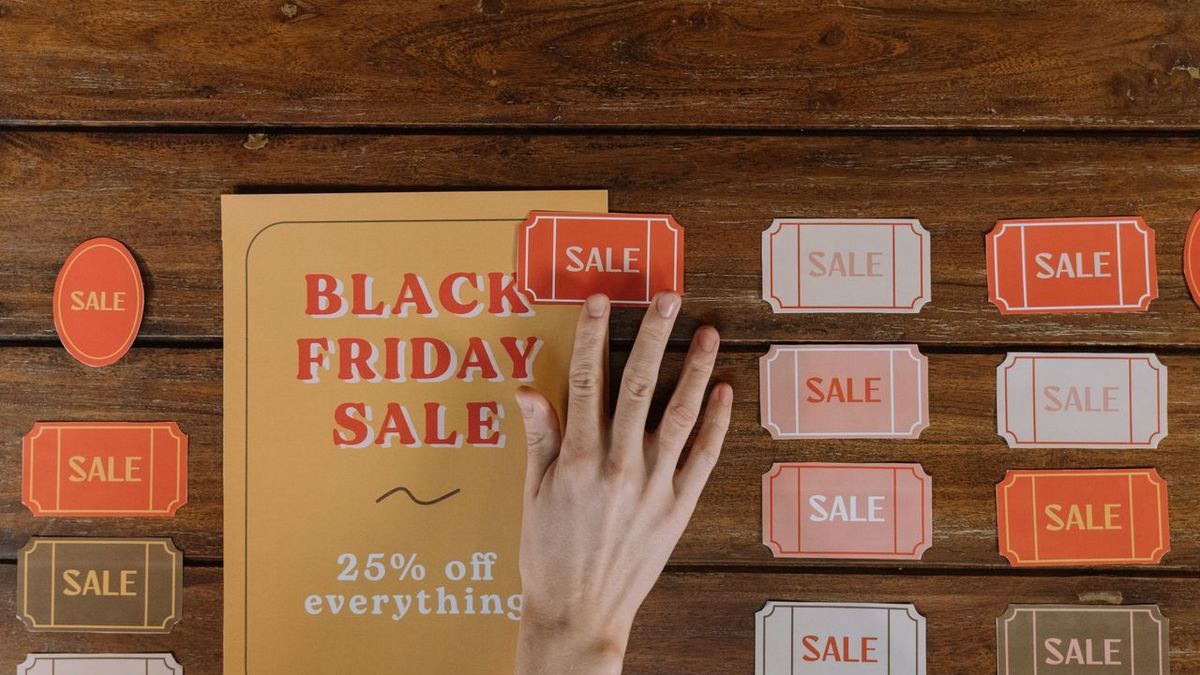 Printed sale and discount templates arranged on a wooden table