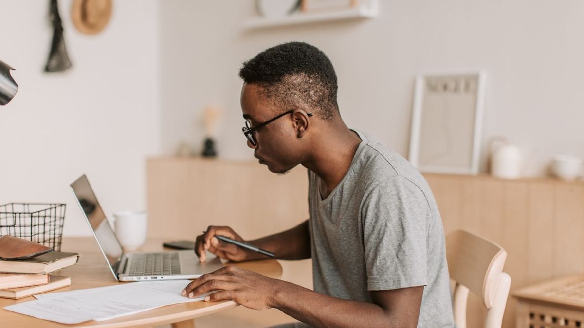 Freelancer working on a laptop at a home office desk
