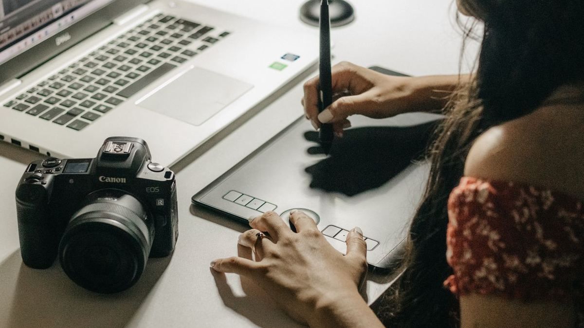 Designer using a graphics tablet next to a camera