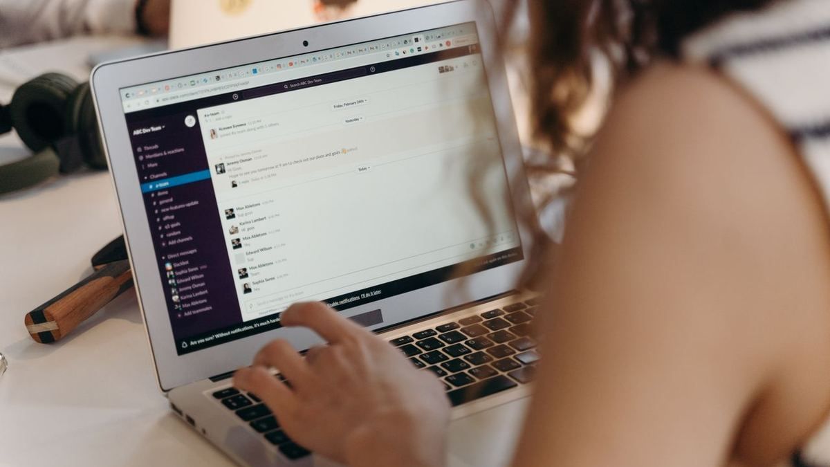 Person typing on a laptop showing a community chat interface
