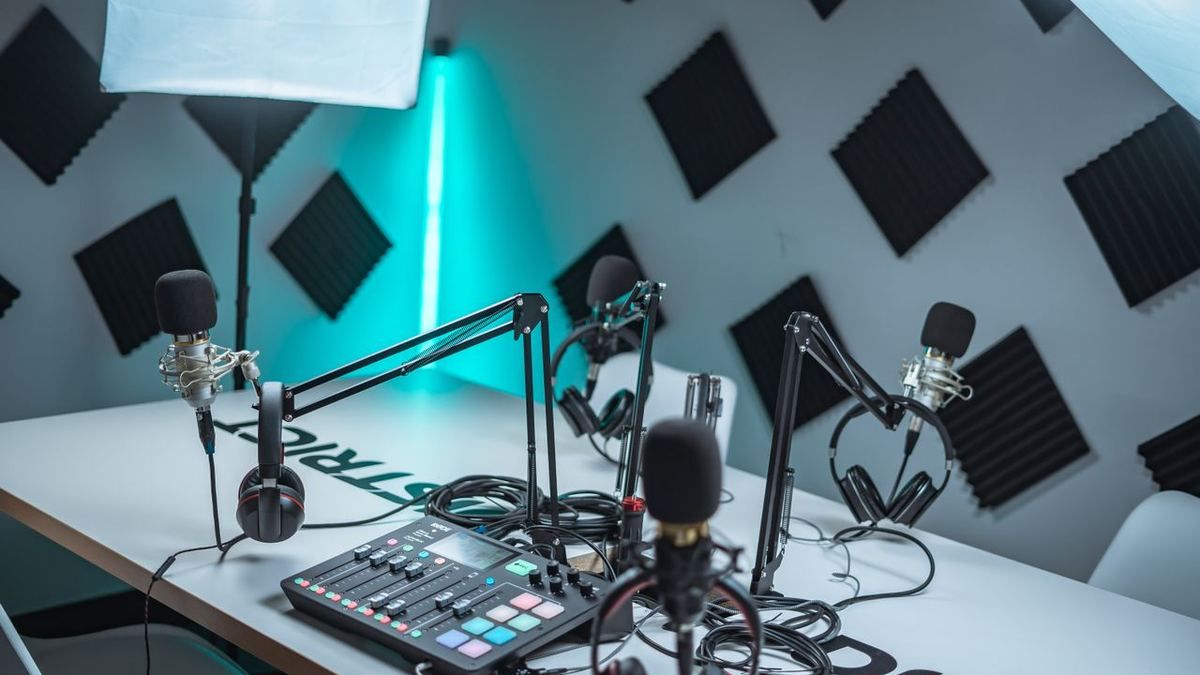 Podcast studio setup with multiple microphones on a desk